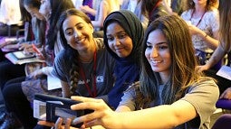 Girls using technology at a conference in London in 2016