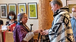 Bobbie Conner, director of the Tamástslikt Cultural Institute, presented a blanket to UO law professor Michael Moffitt at the Many Nations Longhouse on June 3, 2022.