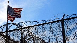 Barbed wire and American flag at detention camp