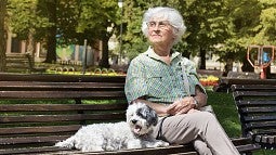 Older woman sitting on park bench