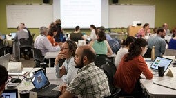 Participants at the 2017 Northwest Regional Summer Institute on Scientific Teaching at the University of Oregon discuss how to support improved student learning outcomes in the sciences and make other improvements to STEM education. Photo courtesy of Dan 