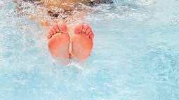 Feet emerging from hot tub
