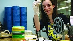Lauren Goss examining old film reels