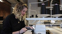 Olivia Echols at sewing machine