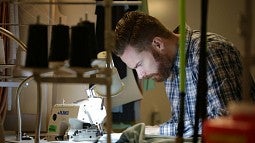 David Parkinson working at a sewing machine