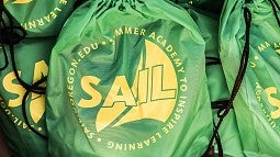 SAIL logo on book bags