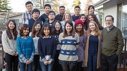 President Schill posing with a group of international students during a Thanksgiving visit in 2015.