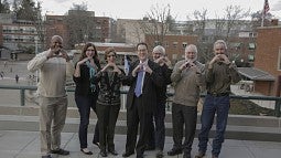 UO President Michael Schill throwing the O with members of the Lane County legislative delegation.