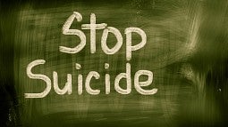 Stop Suicide written on a green chalkboard