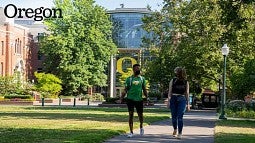 Students walk in front of the Lillis Complex on a warm day (credit: Charlie Litchfield)