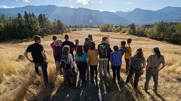 Students gaze at mountains in wolf country