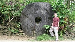 Archaeologist Scott Fitzpatrick with an example of rai on the island of Yap