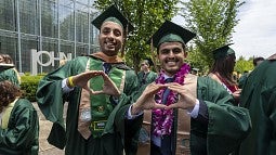 2021 Commencement graduates thowing the O