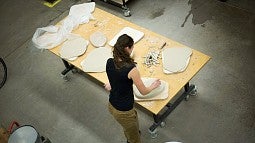 Isabel McDowall removes air bubbles from a dinner plate