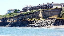 Buildings on a bluff above the ocean