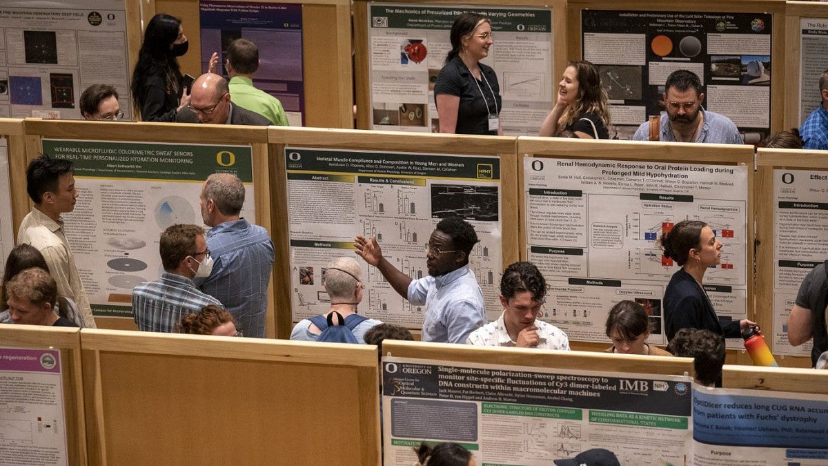 Students explain their research at a poster session