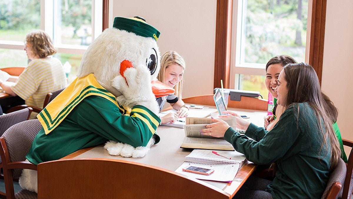 The Duck with students in the library