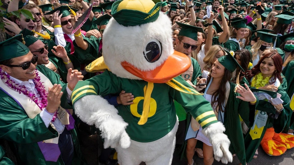 graduated student surround the Duck at commencement