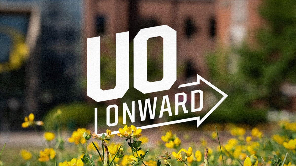 UO Onward printed across a blurred background of a building and flowers planted in front