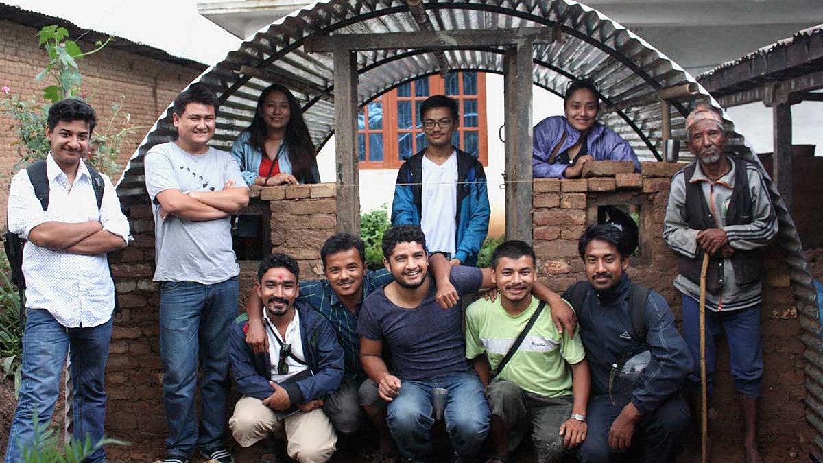 The Aashraya team with a finished emergency shelter