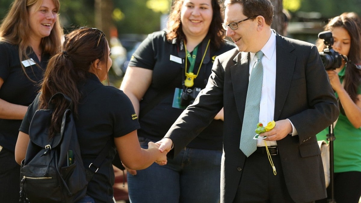 President Michael Schill greets students
