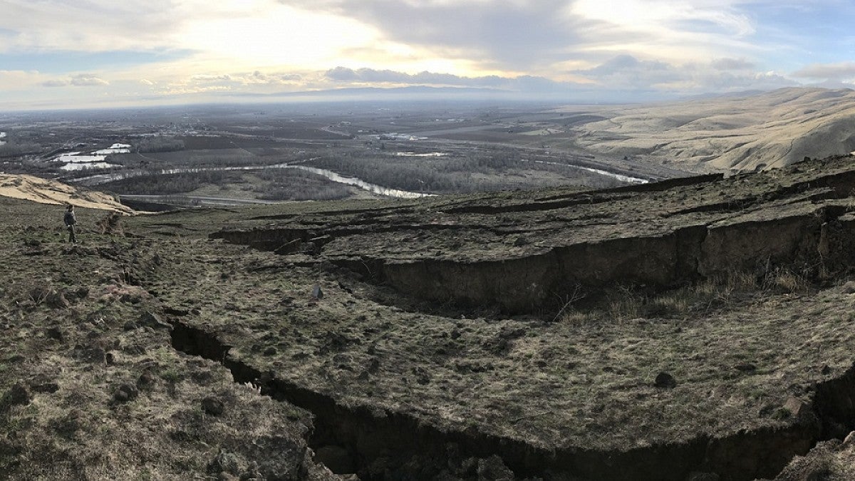 Amanda Thomas looks over deep cracks atop Washington state's Rattlesnake Ridge