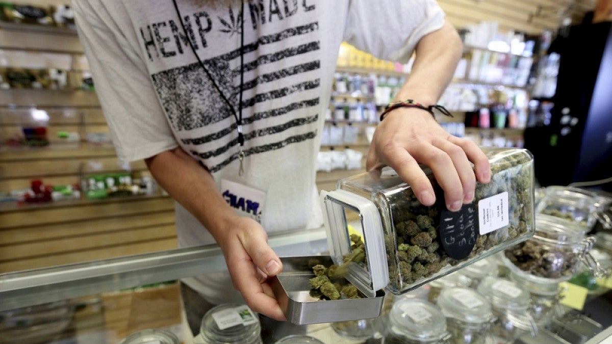 Image shows activity at an Oregon retail marijuana business (Anna Reed, Statesman Journal, via AP)