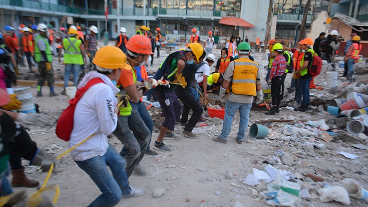 Volunteers remove debris from a collapsed building in Mexico City after the Sept. 19, 2017 Puebla earthquake
