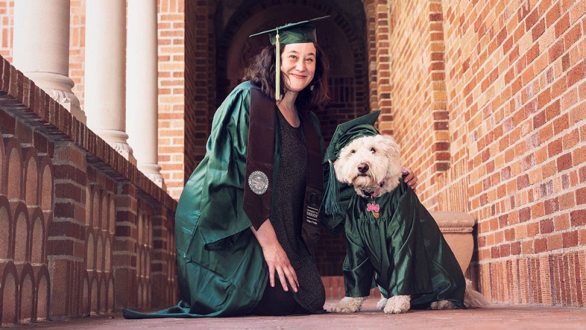 Debbie Williamson Smith and her dog, Pippa, in graduation gear