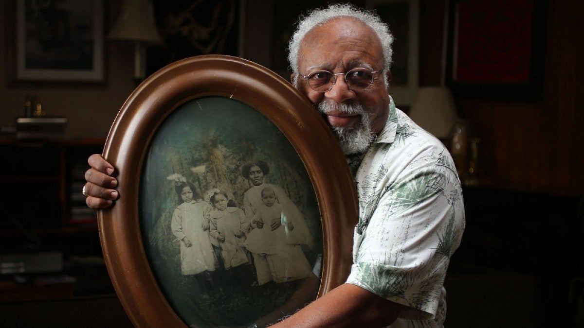 The Ed Coleman, retired UO English professor, holding a family portrait.