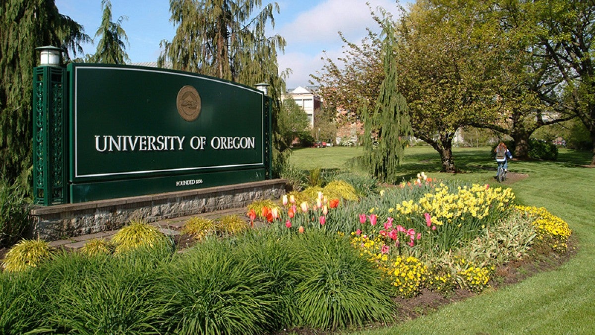 Campus entrance sign with spring flowers