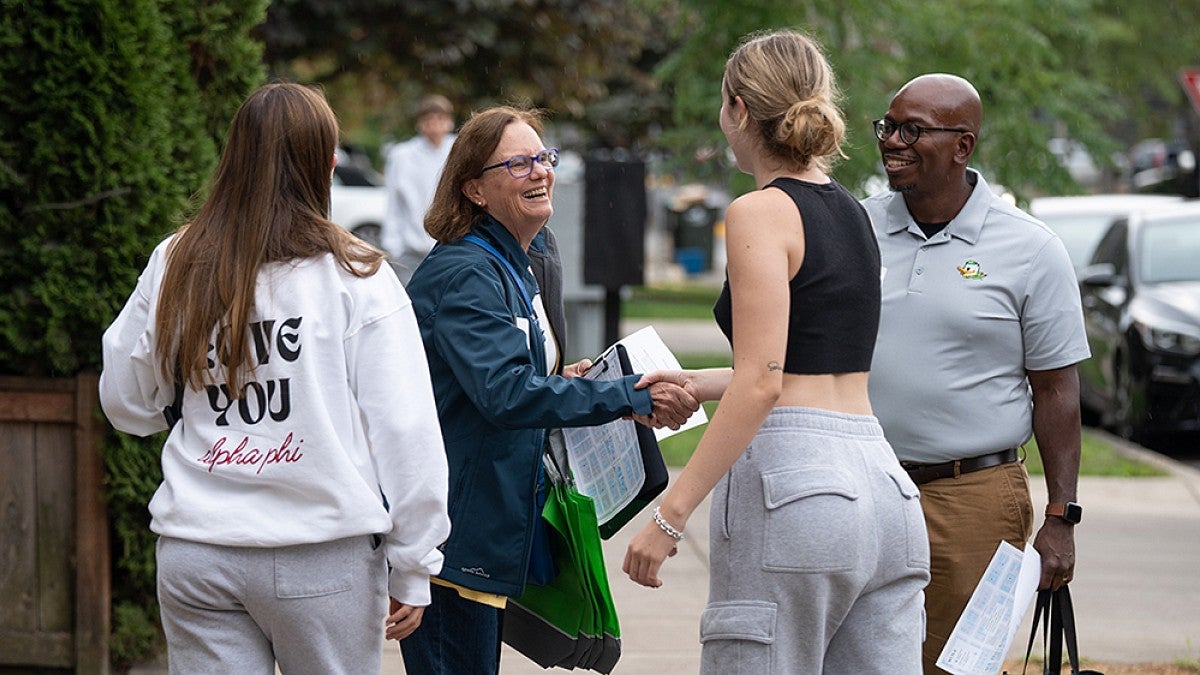Eugene Mayor Lucy Vinis (second from left) and UO Dean of Students Marcus Langford (far right) welcome new students to the neighborhoods around Eugene 