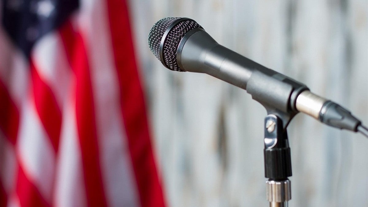 Microphone on stand next to flag