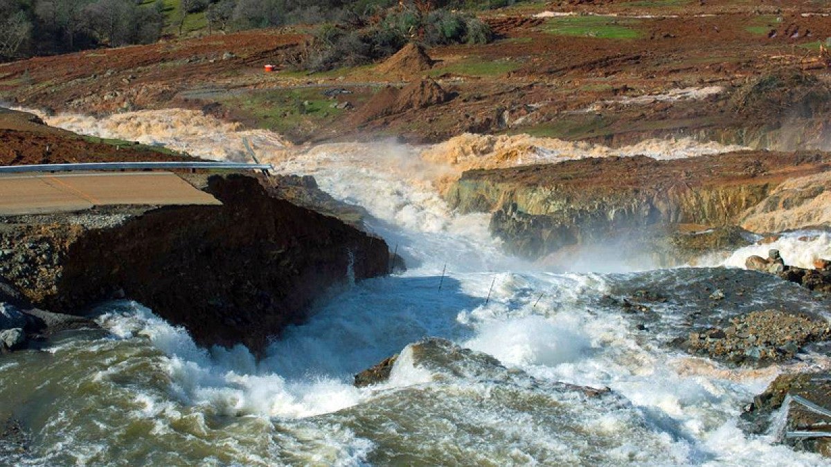 Water pours through the collapsed main spillway at the Oroville Dam