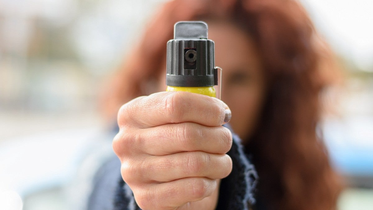 Woman holding pepper spray