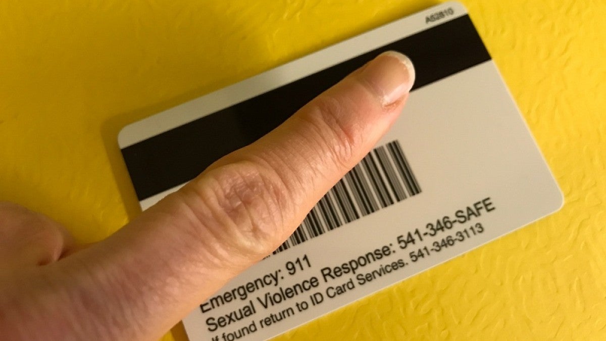 The back of a new ID card with finger pointing to proximity number