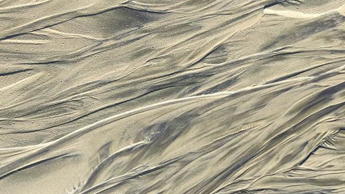 Image shows a portion of a rewashed sand dune, depicting how sandstone forms similary to shale