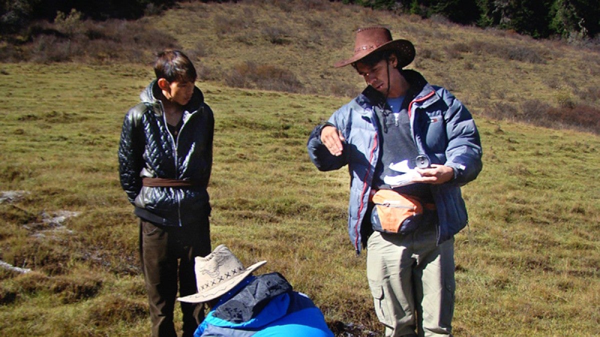 Lucas Silva, standing at right, in the field in Tibet.