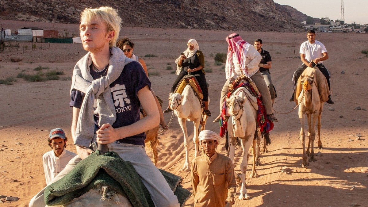Students riding camels in Jordan