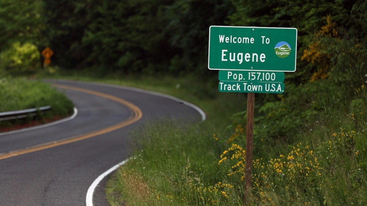 Shot of a winding road with a Eugene sign post