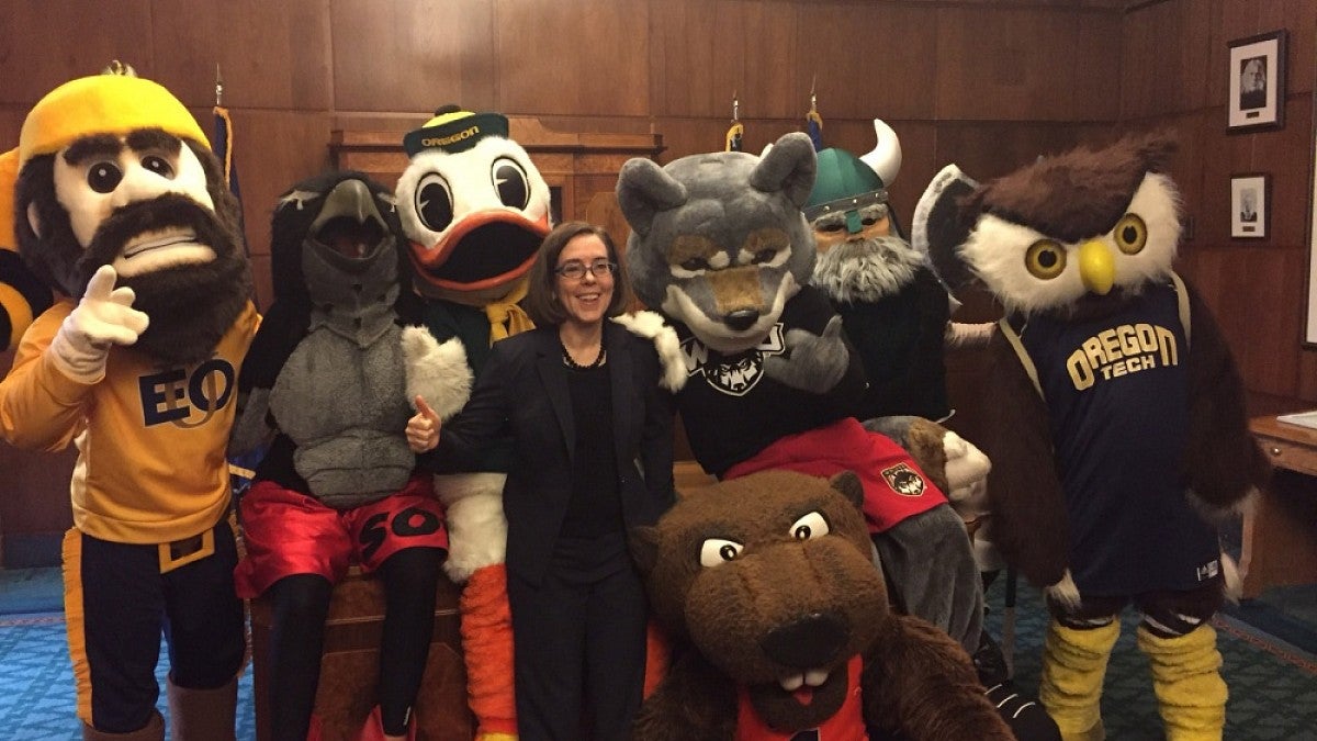 Gov. Kate Brown poses with all seven Oregon university mascots