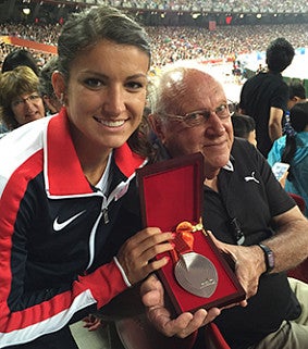 Jenna Prandini with her grandfather Carlos Prandini Sr. holding her silver medal from the 2015 World Championships