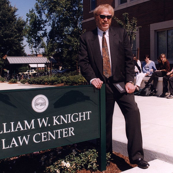 Phil Knight by the William K Knight Law Center sign
