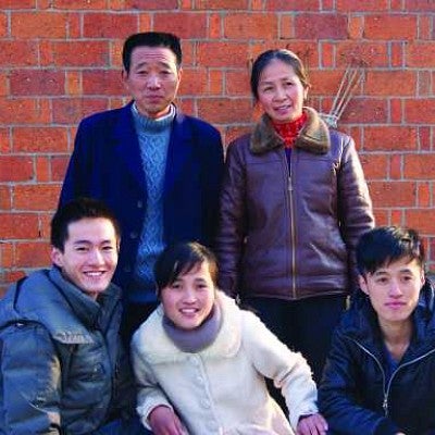 Harris poses with his birth family. Rural families are often allowed exceptions to China's complex one-child policy. Photograph courtesy Wyatt Harris