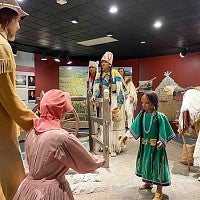An interpretive diorama at the Whitman Mission National Historical Site depicts a peaceful interaction between Cayuse people and Euro-American missionaries.