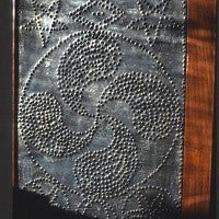 Decorative pattern formed by holes punched in tin